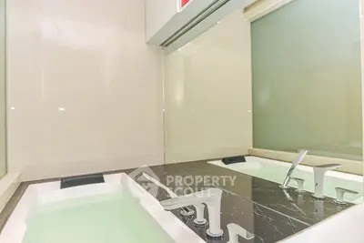 Luxurious bathroom with modern bathtub and sleek fixtures, perfect for relaxation.