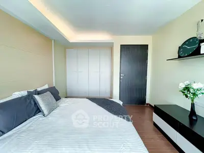 Modern bedroom with sleek design, featuring a cozy bed, stylish decor, and ample storage space.