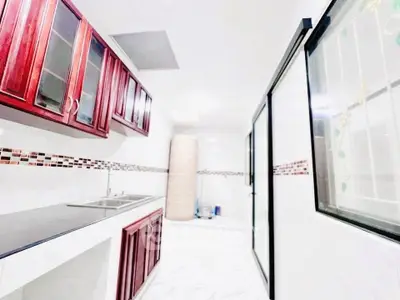 Spacious kitchen with elegant cabinetry and ample natural light.