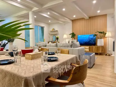 Luxurious open-plan living room with modern decor and elegant dining area