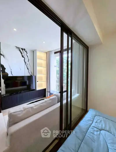 Modern living room with sliding glass doors and elegant marble accent wall