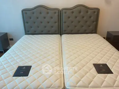 Luxurious bedroom with elegant twin beds and stylish headboard