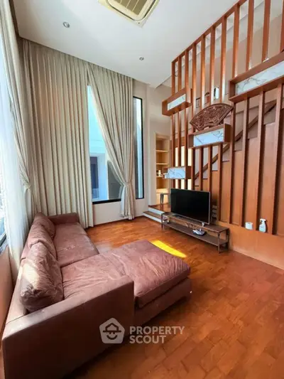 Spacious living room with high ceiling and modern decor