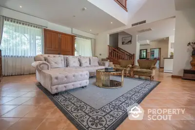 Spacious living room with elegant furniture and large windows in a luxurious home.