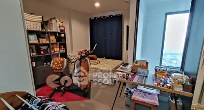 Cozy bedroom with exercise bike and city view window, perfect for urban living.