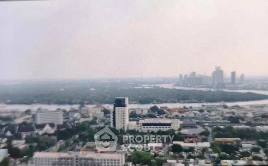 Stunning aerial view of urban skyline with river and skyscrapers, perfect for real estate investment opportunities.