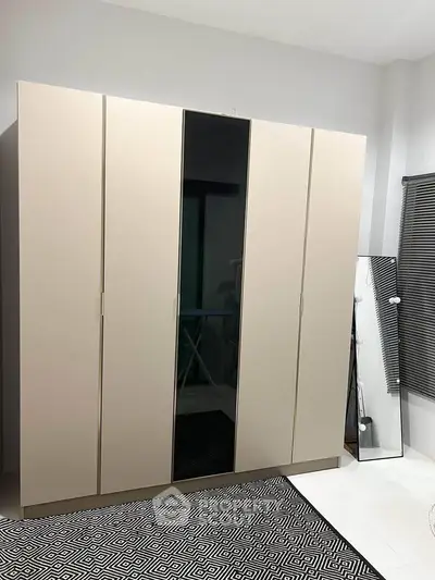 Modern bedroom with sleek wardrobe and stylish decor