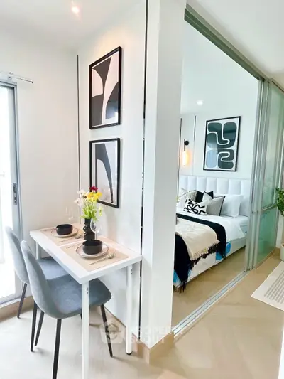 Modern apartment with stylish dining area and cozy bedroom, featuring elegant decor and natural light.