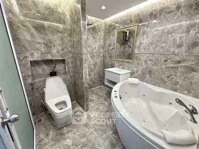 Luxurious marble bathroom with jacuzzi tub and modern fixtures