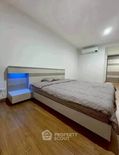 Modern bedroom with stylish bed and ambient lighting