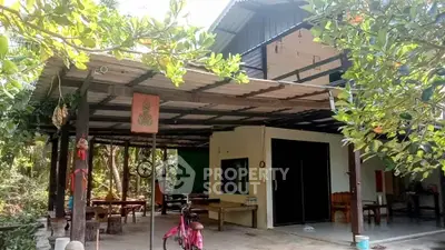 Charming rustic home with spacious outdoor patio and lush greenery, perfect for nature lovers.