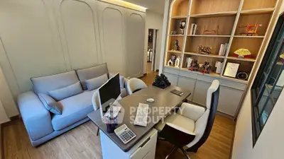 Modern study room with sleek desk, comfortable seating, and stylish shelving.