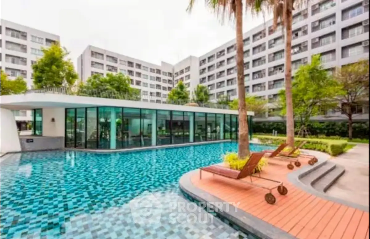 Luxurious apartment complex with stunning pool and lush greenery, perfect for relaxation and modern living.