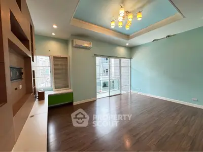 Spacious living room with modern lighting and large windows in a stylish apartment.