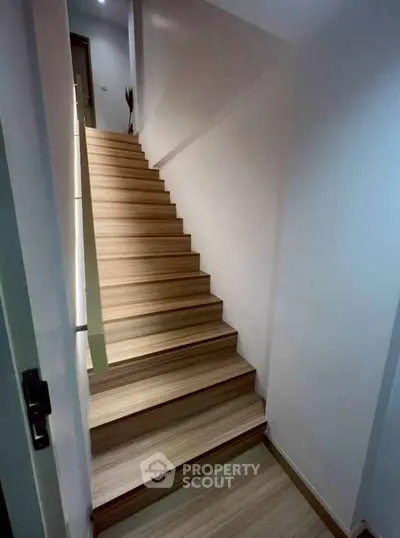 Modern wooden staircase with sleek design in a contemporary home interior