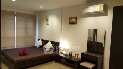 Modern bedroom with cozy decor and air conditioning in stylish apartment