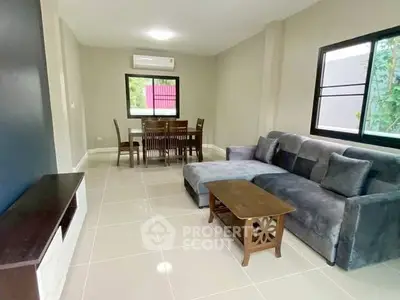 Spacious living room with modern furniture and large windows for natural light.