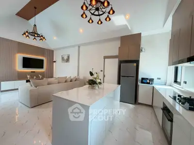 Luxurious open-plan kitchen and living room with modern decor and high-end appliances.