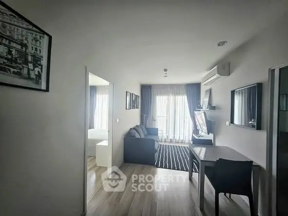 Modern living room with stylish decor and natural light, featuring a cozy sofa and elegant furnishings.