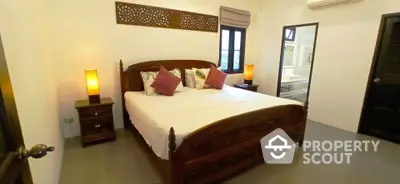 Elegant bedroom with traditional wooden bed frame, matching nightstands, and warm ambient lighting, perfect for a restful retreat.