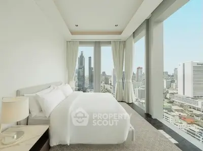Luxurious bedroom with panoramic city view and elegant decor in high-rise apartment.