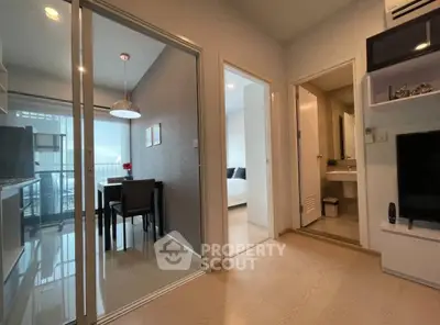 Modern apartment interior with open living space and dining area, featuring sleek design and natural light.