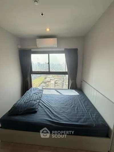 Modern bedroom with city view, featuring a large window and minimalist design, perfect for urban living.