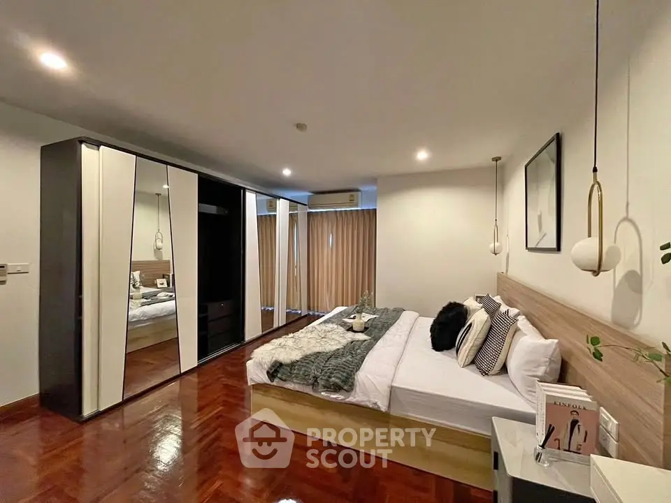 Spacious modern bedroom with elegant decor and large wardrobe