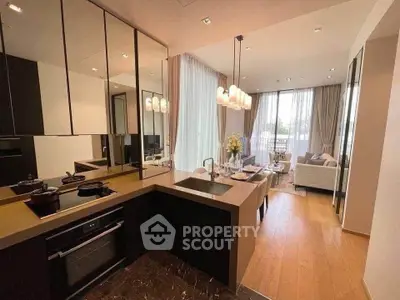 Modern open-layout kitchen with sleek design and spacious living area, featuring elegant lighting and large windows.