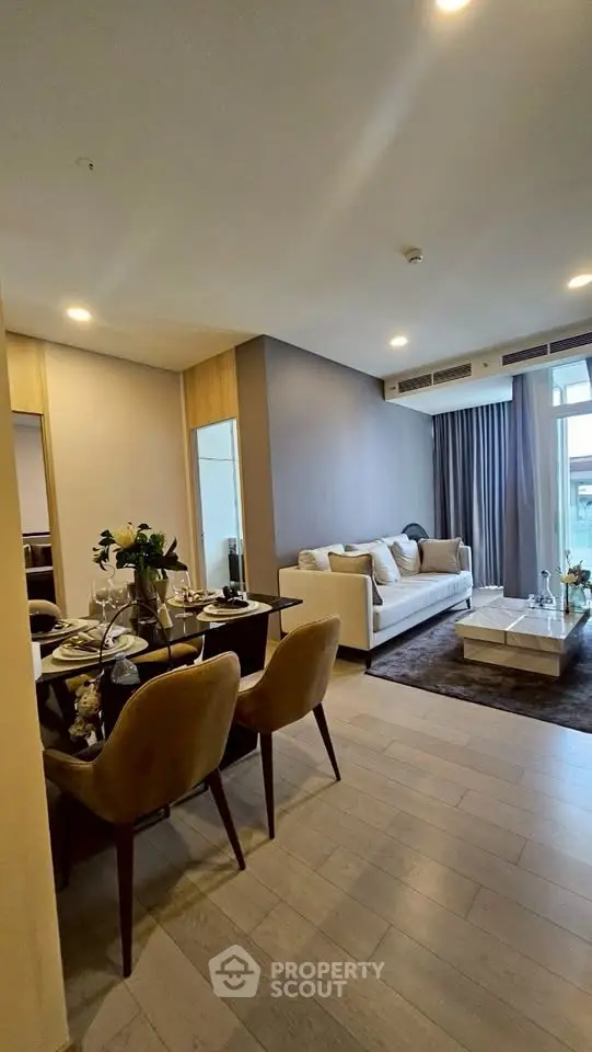 Modern living room with elegant dining area and cozy sofa, featuring stylish decor and natural light.