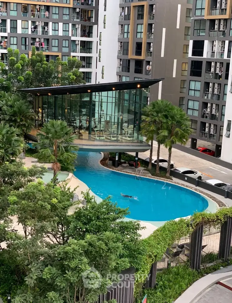 Modern condominium with luxurious pool and lush greenery in urban setting