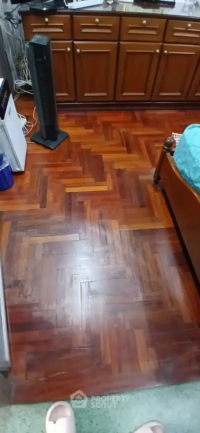 Cozy bedroom with wooden flooring and classic furniture