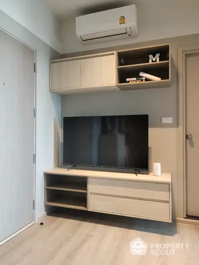 Modern living room with sleek TV unit and air conditioning