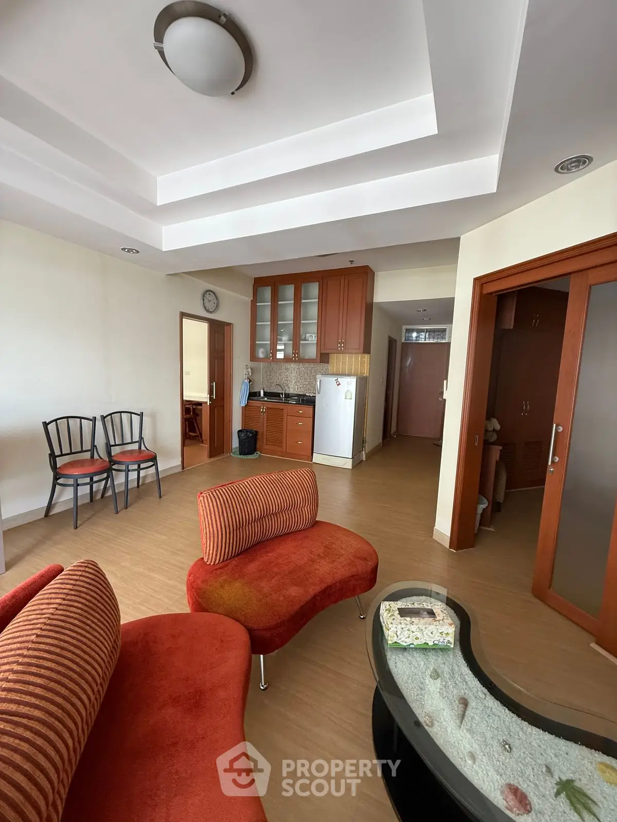 Spacious living room with modern furniture and open kitchen layout in a stylish apartment.