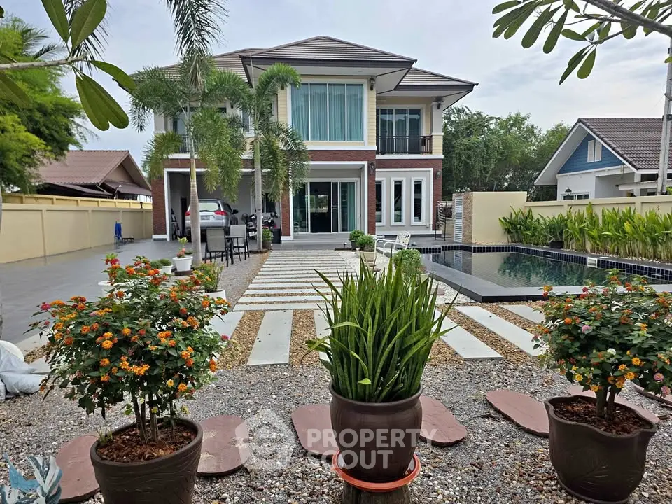 Luxurious modern house with pool and landscaped garden in serene neighborhood.