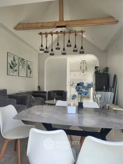 Spacious living room with modern dining area and vaulted ceiling