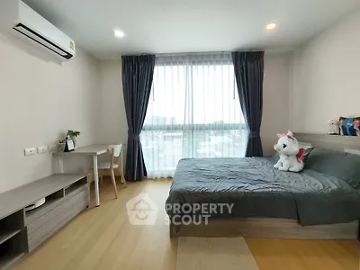 Modern bedroom with large window and stylish decor
