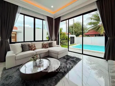 Luxurious living room with pool view and modern decor