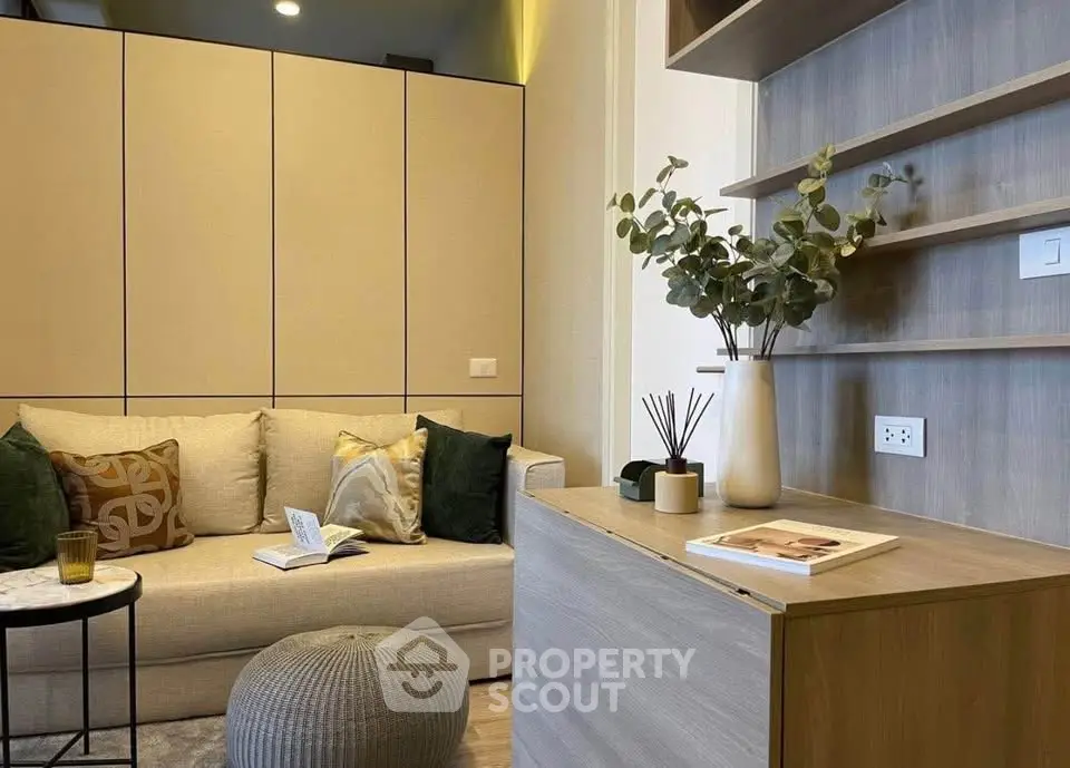Modern living room with cozy sofa, stylish decor, and elegant shelving in a contemporary apartment.