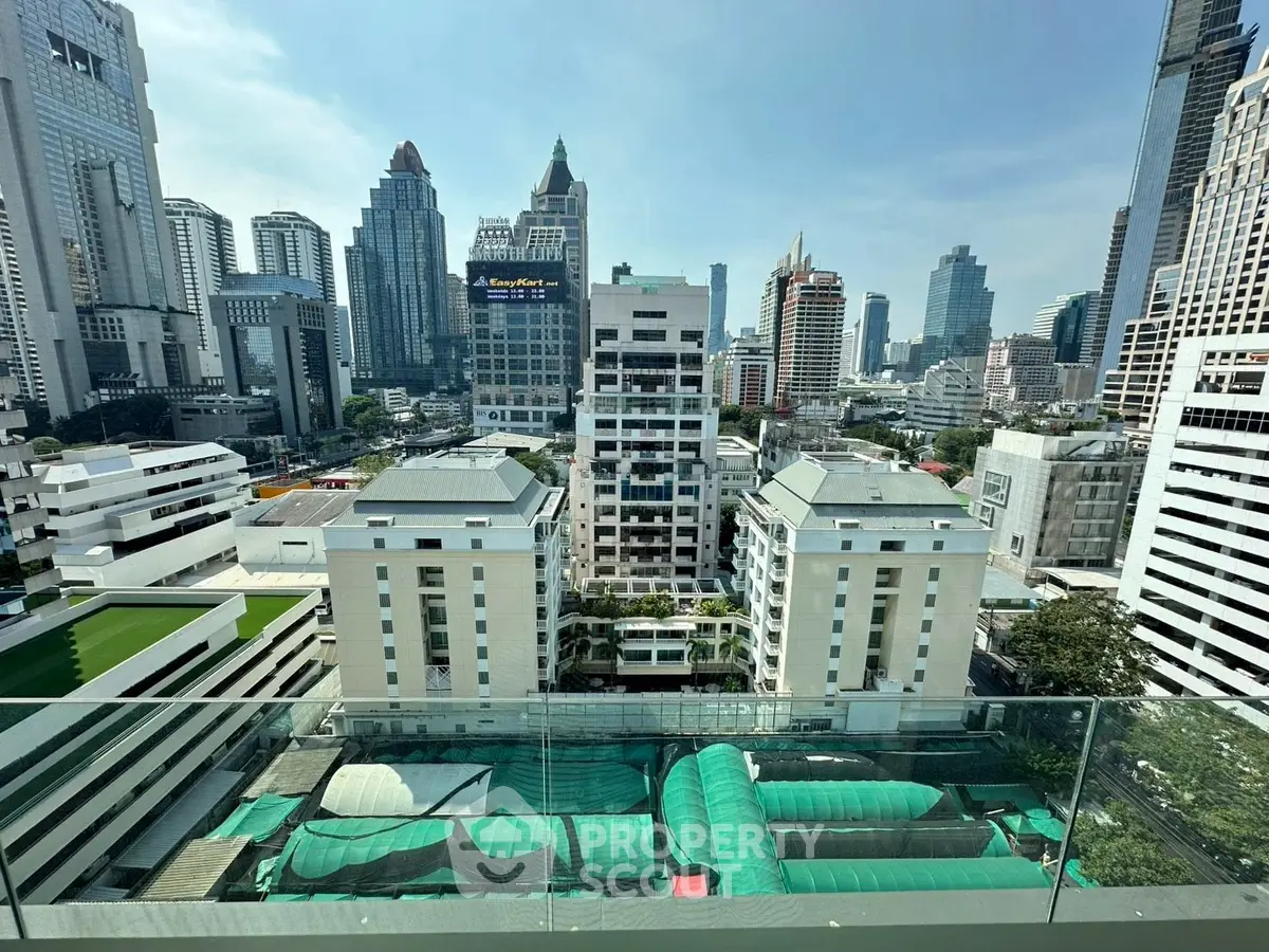 Stunning cityscape view from a high-rise balcony in a bustling urban area.