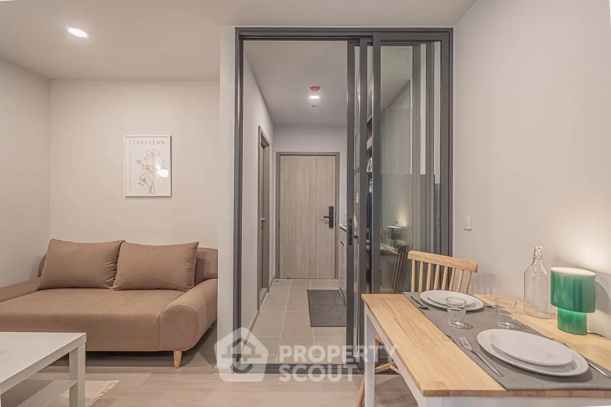 Modern apartment interior with cozy living room and dining area, featuring stylish furniture and warm lighting.