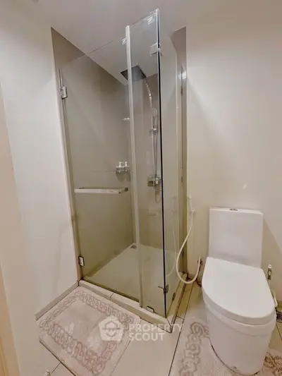 Modern bathroom with glass shower and sleek toilet design