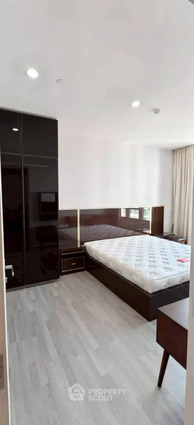 Spacious modern bedroom with sleek furniture and natural light