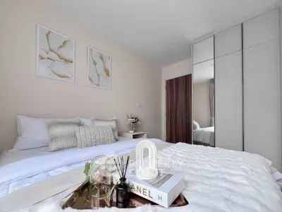 Elegant bedroom with modern decor and cozy bedding