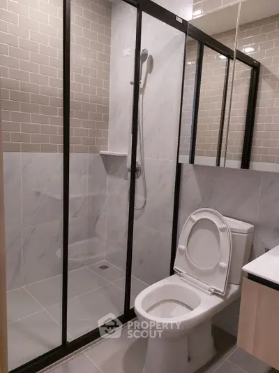 Modern bathroom with glass shower and sleek tile design