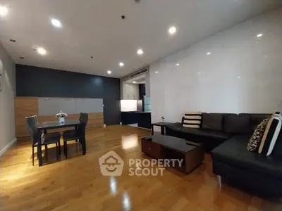 Spacious modern living room with wooden flooring and stylish furniture
