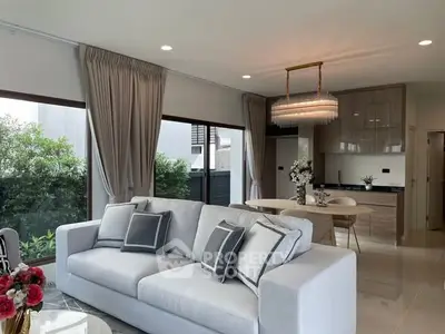 Elegant living room with modern decor and open kitchen layout