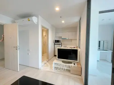Modern apartment interior with open layout, featuring a cozy living area and sleek kitchen design.