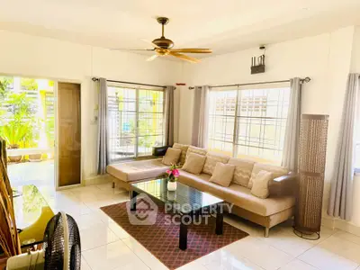 Spacious living room with modern decor and large windows for natural light.