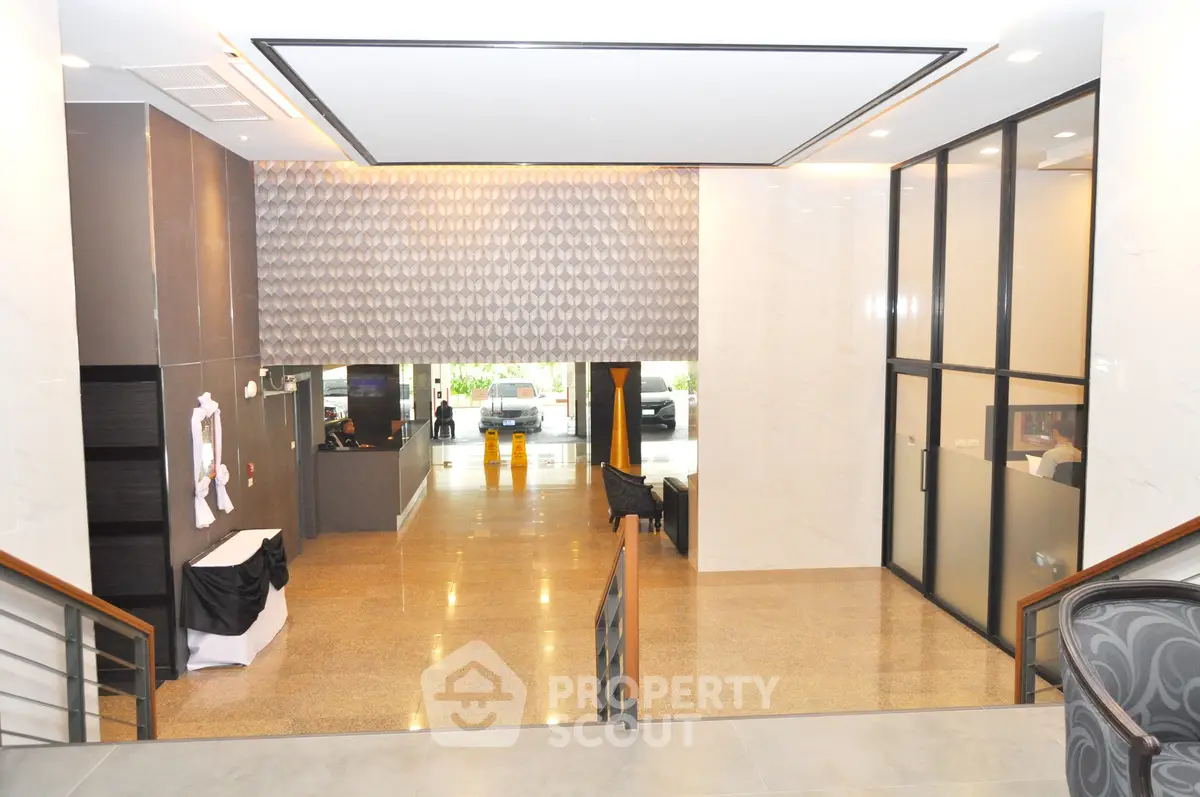 Modern building entrance with sleek design and spacious lobby area